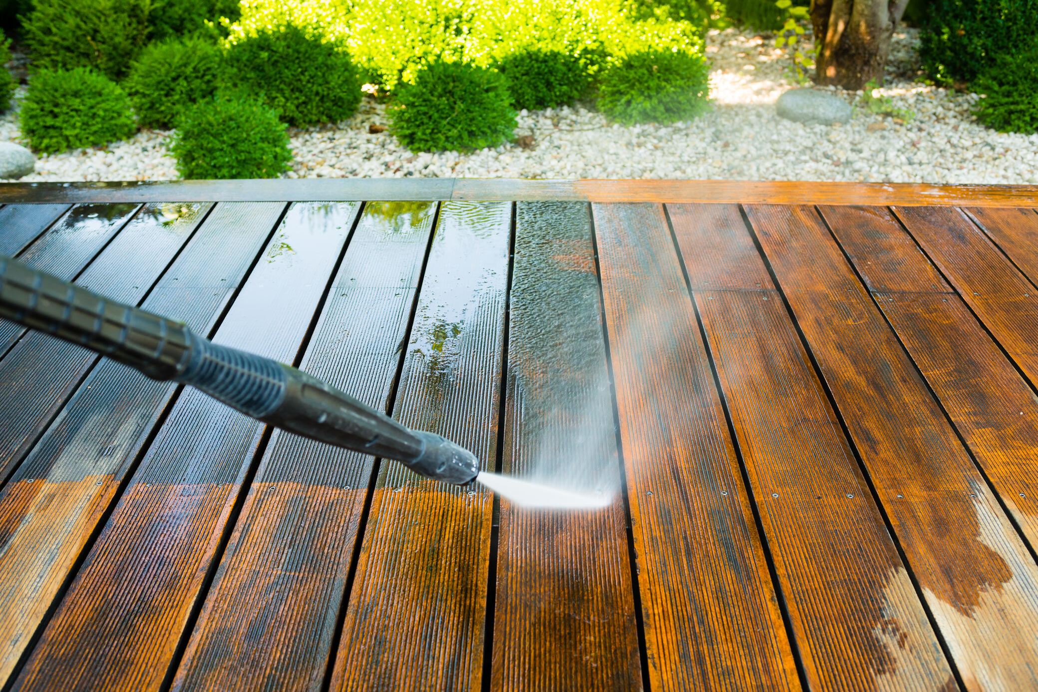 wood deck being pressure washed